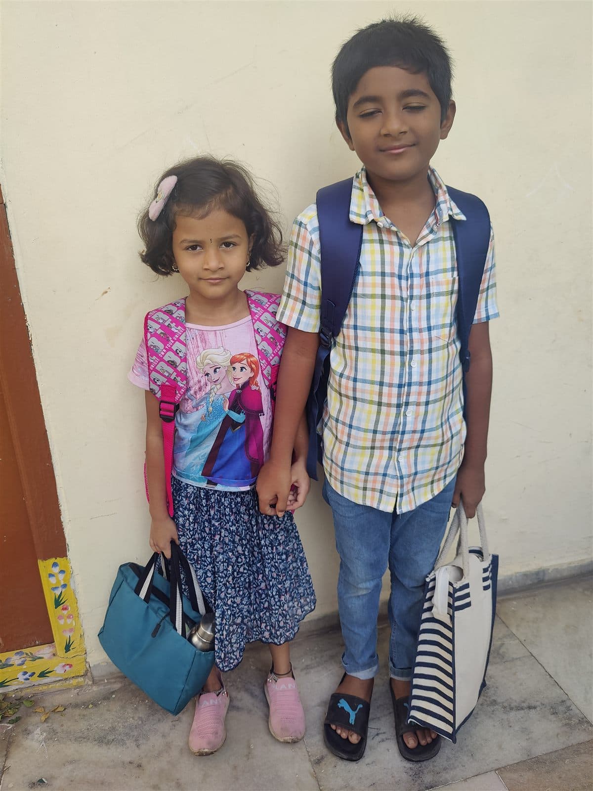 Nihan with his sister Chaithrika, both carrying school-style bags