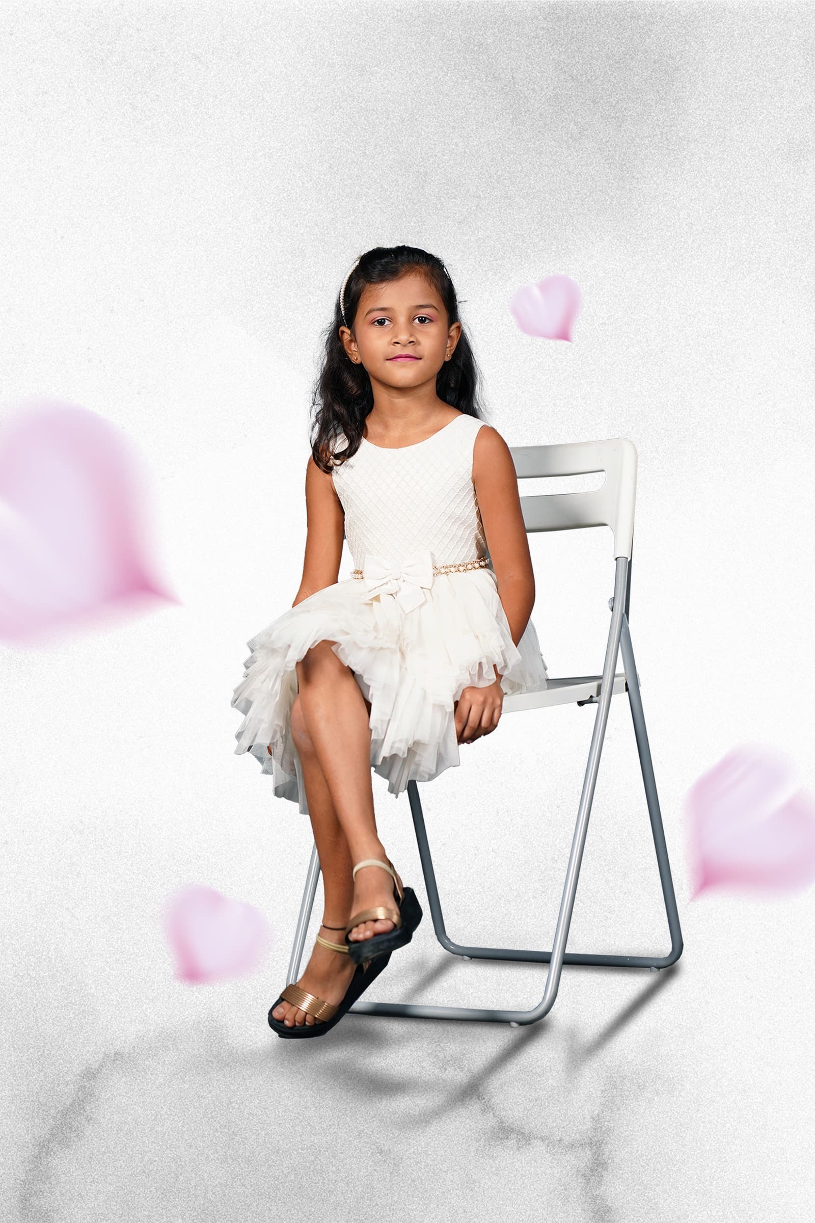Chaithrika in white dress on chair